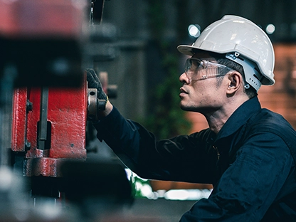 Z Solution person working on red machine